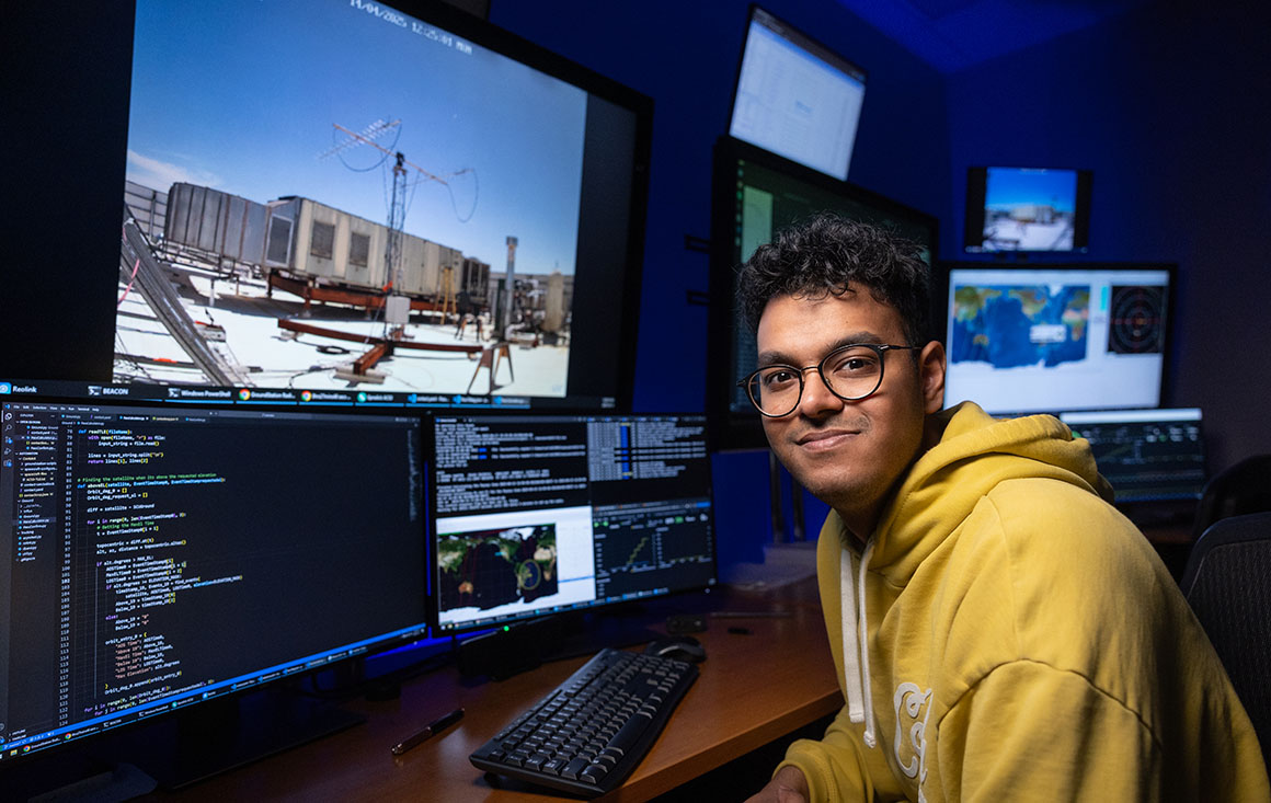 Prajit Saravanan sitting at desk doing mission control tasks for NASA